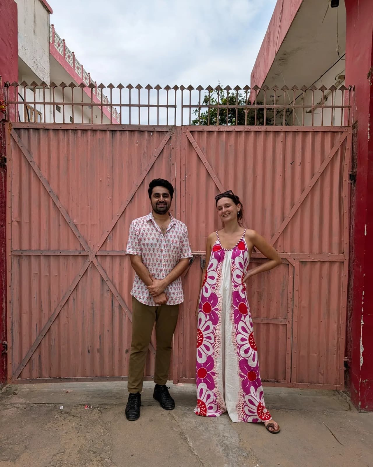 Camille standing with one of the family makers outside the workshop gates in Rajasthan